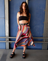 This Y2k skirt serves pure elegance with its flowing silhouette and vibrant geometric print in magenta, teal, orange, and warm brown. Light and easy to wear, it’s comfortable and anything but boring—designed for those who dress with intention.