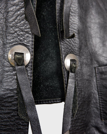 Embrace your inner rebel with this vintage 80s 90s black biker leather vest! Perfect for adding a touch of edge to any outfit, this vest is full of personality and attitude. Made with genuine leather, it offers both style and durability.