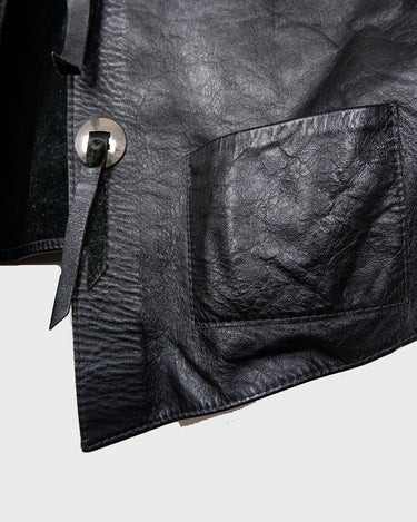Embrace your inner rebel with this vintage 80s 90s black biker leather vest! Perfect for adding a touch of edge to any outfit, this vest is full of personality and attitude. Made with genuine leather, it offers both style and durability.