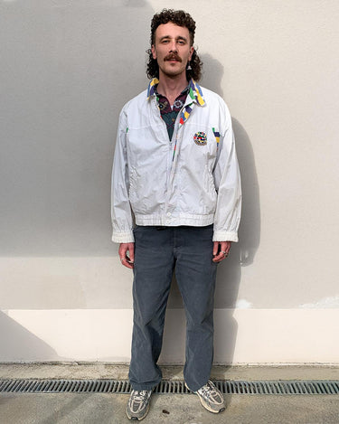 This vintage Missoni Sport windbreaker from the 90s is a standout piece with its bold striped accents and iconic globe logo embroidery. Made in Italy and cut in a comfortable size L, it offers a relaxed fit and lightweight feel – ideal for everyday wear. A rare example of Missoni’s sporty aesthetic, combining timeless design with a splash of color. Effortlessly cool and easy to style.