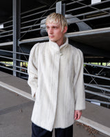 Wrap yourself in timeless elegance with this vintage off-white alpaca and mohair coat by AlmoFlor. Featuring a luxurious soft texture and subtle vertical stripe detailing, this piece exudes classic sophistication and understated glamour.