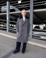 This long checked overcoat in grey tones with subtle red accents combines classic tailoring with a modern edge. The soft real fur collar adds warmth and texture, while the relaxed fit ensures versatile styling. Ideal for elevating everyday looks in cooler weather.