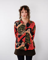 a woman is wearing a Vintage 90s pattern long sleeve blouse size S-M by vinti vintage online shop