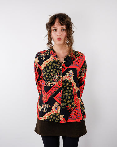 a woman is wearing a Vintage 90s pattern long sleeve blouse size S-M by vinti vintage online shop