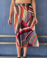 This Y2k skirt serves pure elegance with its flowing silhouette and vibrant geometric print in magenta, teal, orange, and warm brown. Light and easy to wear, it’s comfortable and anything but boring—designed for those who dress with intention.