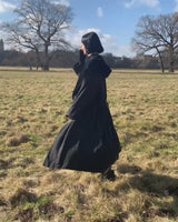 Add some edge to your wardrobe with this Vintage 80s/90s wool coat. The dark grey/black color combination and velvet hood give off a grunge vibe!