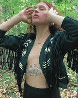 Unleash your inner rebel with this vintage 80s black leather crop fringe jacket. Made from high-quality leather, this XS jacket features fringe detailing that will make a statement. 