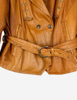 a woman is wearing a brown leather jacket.