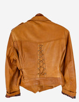 a woman is wearing a brown leather jacket.