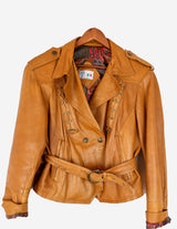 a woman is wearing a brown leather jacket.