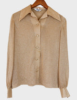 a woman is wearing a glitter blouse.