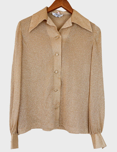 a woman is wearing a glitter blouse.
