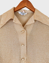 a woman is wearing a glitter blouse.