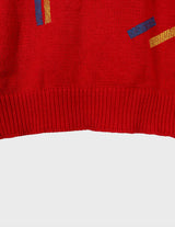 a woman is wearing a vintage 70s 80s red slipover.