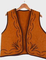 a woman is wearing a brown vest.