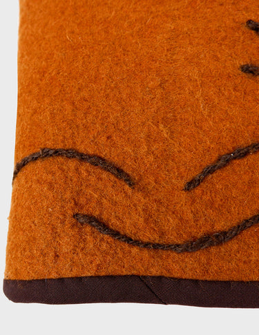 a woman is wearing a brown vest.