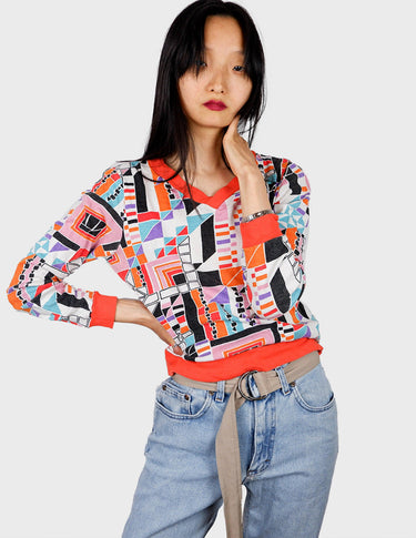 a woman is wearing a colorful shirt.