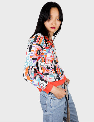 a woman is wearing a colorful shirt.