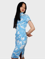 a woman is wearing a cotton asian dress.