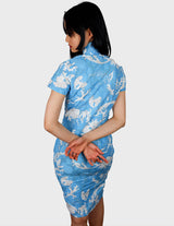 a woman is wearing a cotton asian dress.