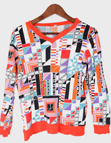 a woman is wearing a colorful shirt.
