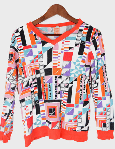 a woman is wearing a colorful shirt.