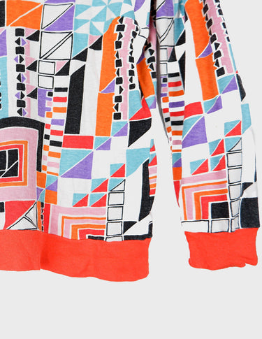 a woman is wearing a colorful shirt.