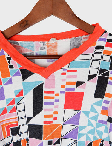a woman is wearing a colorful shirt.