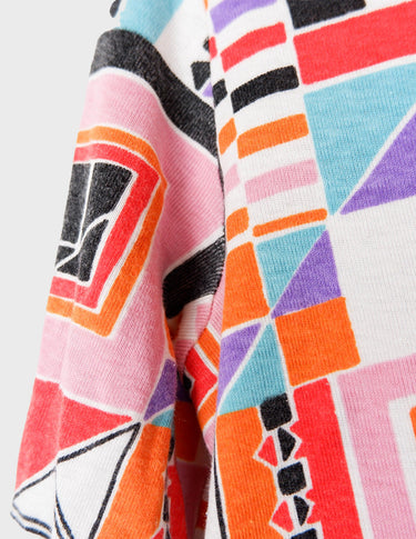 a woman is wearing a colorful shirt.