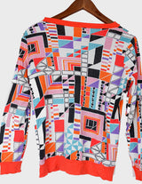 a woman is wearing a colorful shirt.