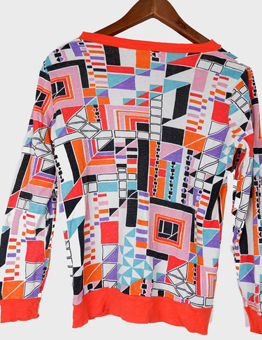a woman is wearing a colorful shirt.