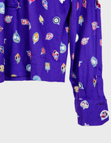 a woman is wearing a purple shirt.