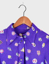 a woman is wearing a purple shirt.