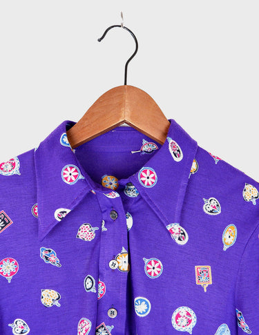a woman is wearing a purple shirt.