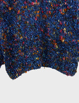 a woman is wearing a handknitted sweater.