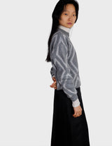 a woman is wearing a 80s vintage glitter sweater.