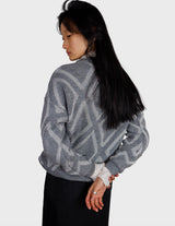 a woman is wearing a 80s vintage glitter sweater.