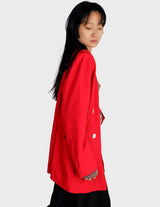 a woman is wearing a red 80s vintage blazer.