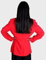 a woman is wearing a red 80s vintage blazer.