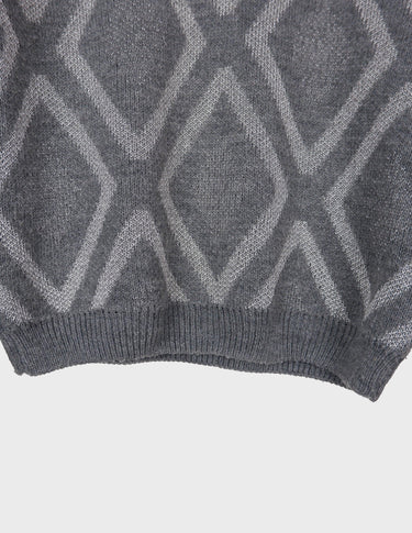 a woman is wearing a 80s vintage glitter sweater.