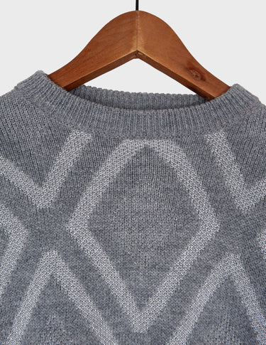 a woman is wearing a 80s vintage glitter sweater.