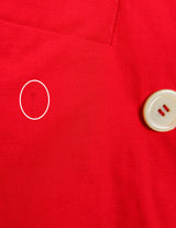 a woman is wearing a red 80s vintage blazer.