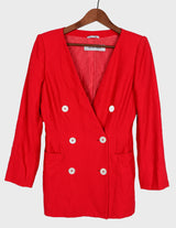 a woman is wearing a red 80s vintage blazer.