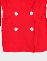 a woman is wearing a red 80s vintage blazer.