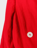 a woman is wearing a red 80s vintage blazer.