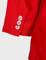 a woman is wearing a red 80s vintage blazer.