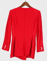 a woman is wearing a red 80s vintage blazer.