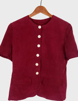 a woman is wearing a 90s burgundy shirt.