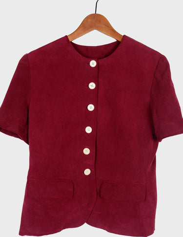 a woman is wearing a 90s burgundy shirt.