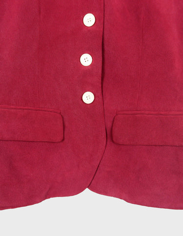 a woman is wearing a 90s burgundy shirt.